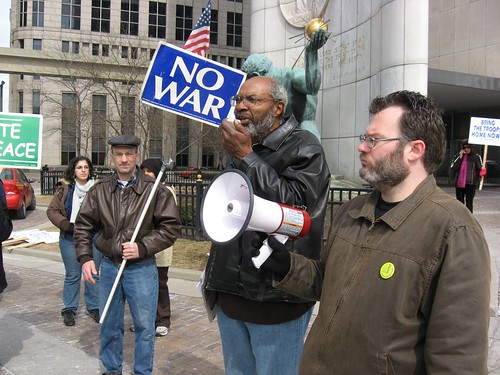 Abayomi Azikiwe, editor of the Pan-African News Wire, speaking to the people in downtown Detroit on March 15, 2008. Bryan Pfeifer of the AFT holds bullhorn. (Alan Pollock). by Pan-African News Wire File Photos