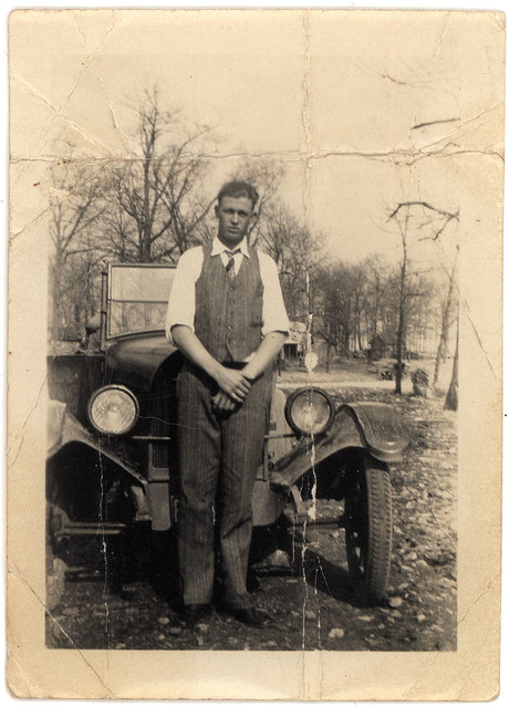 vintage man in front of old car Not exact on the year but probably the 