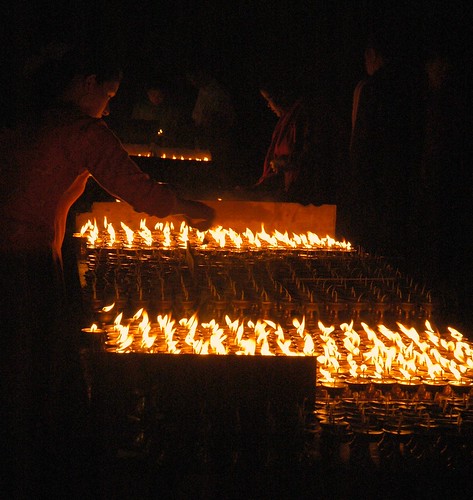 Butter lamps and Candles for offering, street, Boudha, Kathmandu by Wonderlane