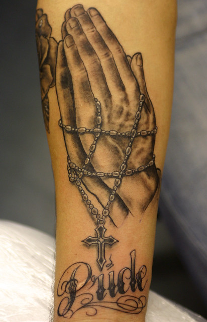 Rosary beads and praying hands
