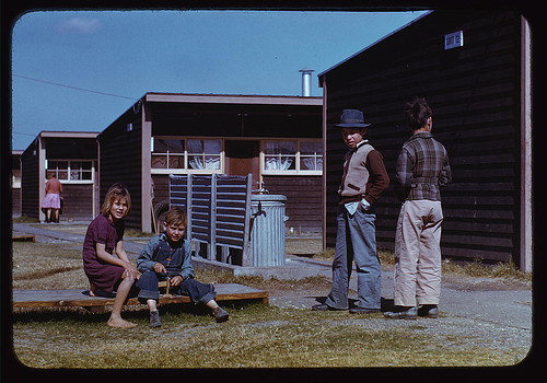 Boy building a model airplane while other children look on, FSA labor camp, Robstown, Tex. (LOC)