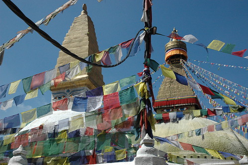 The eastern eyes of Lord Buddha, Boudha Stupa, the Wish Fullfilling, prayer flags old and new, power cable, clear sunny day, Tibetan Buddhism, Kathmandu, Nepal by Wonderlane
