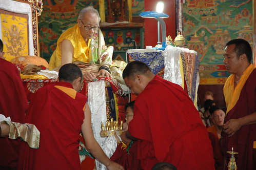 With the help of senior lamas, a very young lama HE Asanga Rinpoche preparing to offer the Mandala of the Universe to his grandfather, HH Jigdal Dagchen Sakya, Tharlam Monastery, Nepal by Wonderlane