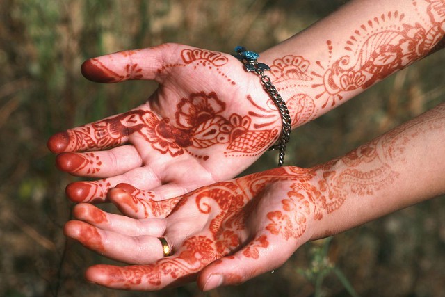 A Kashmiri girl displaying beautiful design of hena on her hands