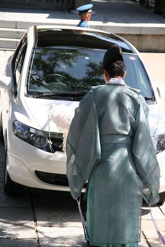 Priest blessing a car