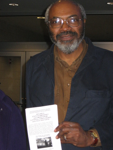 Abayomi Azikiwe, editor of the Pan-African News Wire, holding a leaflet at Cobo Conference Center in downtown Detroit. MECAWI won a federal court order related to its ability to distribute information on the foreclosure crisis. (Photo: Cheryl LaBash). by Pan-African News Wire File Photos