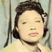 Tinted photobooth image of a black woman