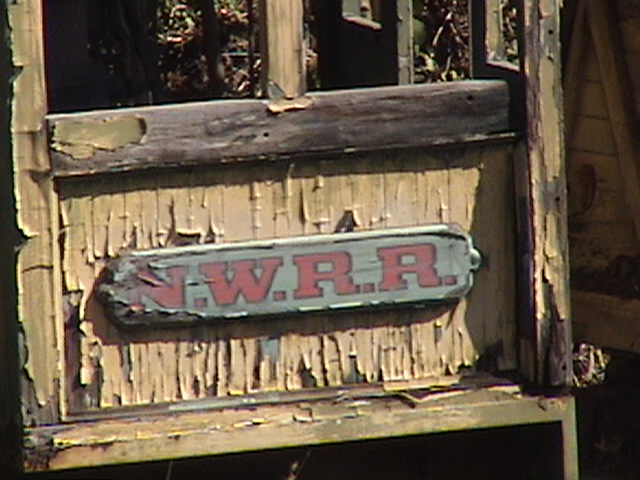 N.W.R.R. letterboard on locomotive cab of Mine Train thru Nature's Wonderland wreck display on the Rivers of America