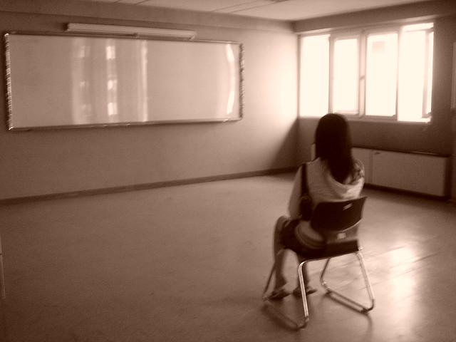 photo of woman sitting alone in room