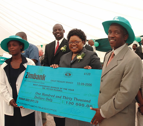 Zimbabwe Vice President Hon. J.T.R. Mujuru presenting a cheque to Never Maroka on achieving Extension Worker of the Year award sponsored by Pannar Seed Company. by Pan-African News Wire File Photos