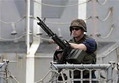 A U.S sailor stands on guard on the deck of the warship Bainbridge upon arrival at the port of Mombasa, Kenya, 500km from the capital Nairobi, April 16, 2009. by Pan-African News Wire File Photos