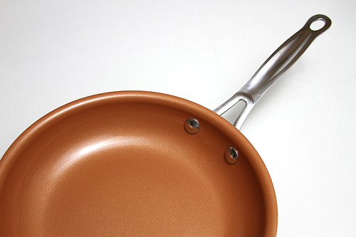 Closeup of bronze skillet and stainless steel handle