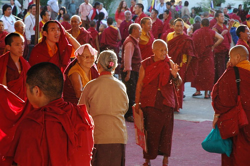 Tibetan Buddhists; Nuns, laypeople, monks greet each other, with fluff flying in the air, Tibetan religious community, Tharlam Monastery of Tibetan Buddhism, break, Sakya Lamdre, Boudha, Kathmandu, Nepal by Wonderlane