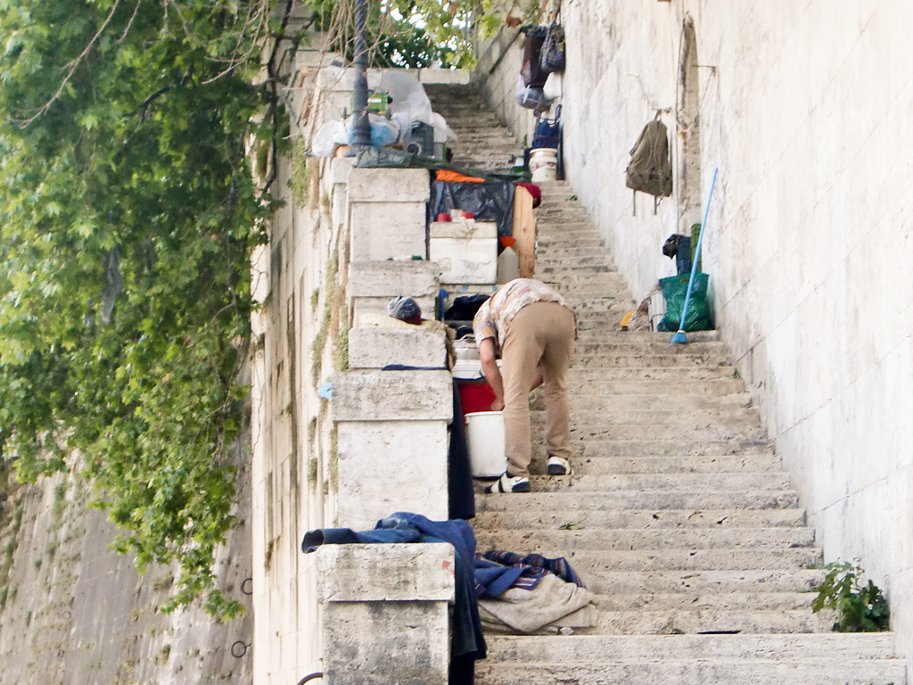 Homeless living in a staircase down to the river Tiber