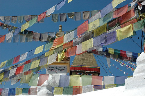 Boudha Wishfulfilling Stupa looking over colorful rows of Tibetan Prayer Flags in the east, Kathmandu, Nepal by Wonderlane