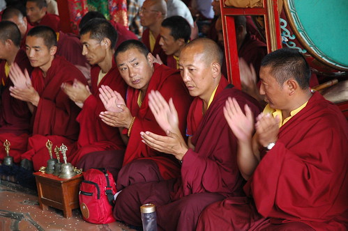 Lamas clapping hands mudra to dispel inner and outer darkness and negativity, Sakya Lamdre, Tharlam Monastery of Tibetan Buddhism, Boudha, Kathmandu, Nepal by Wonderlane