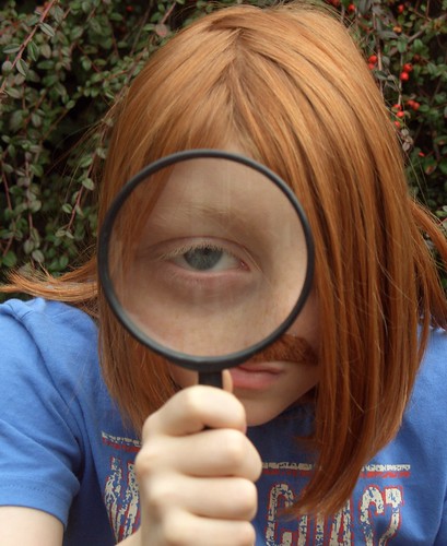 Red-headed kid with a magnifying glass