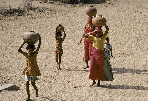 Women and children carry water