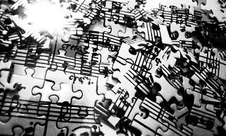Strewn pieces of a jigsaw of a musical score