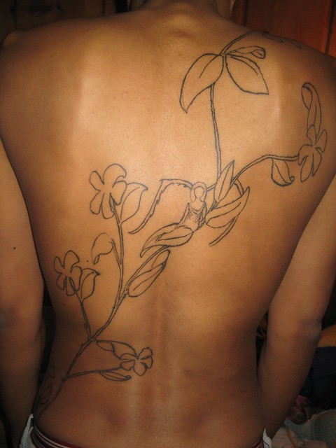The design is a vine of jasmine leaves and flowers with an angel sitting on