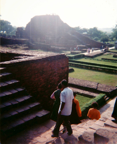 People walking through the famed huge Buddhist Nalanda University & Monastery ruins, brick stupas, ransacked & destroyed by Turkic Muslim invaders in 1193, Bihar, India, 1993 by Wonderlane