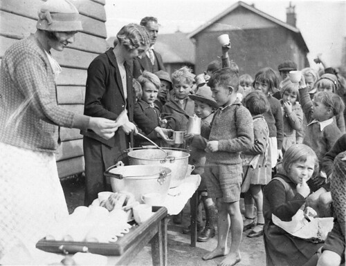 Schoolchildren line up for free issue of soup and a slice of bread in the Depression, Belmore North Public School, Sydney, 2 August 1934 / Sam Hood
