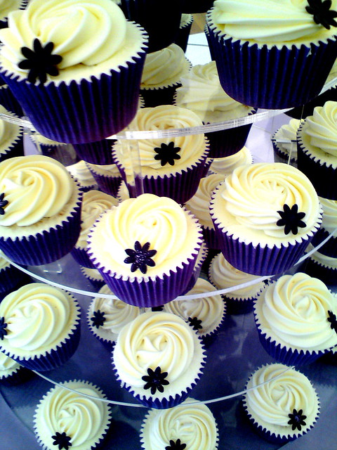 Close up shot of purple vanilla wedding cupcakes topped with creamy vanilla