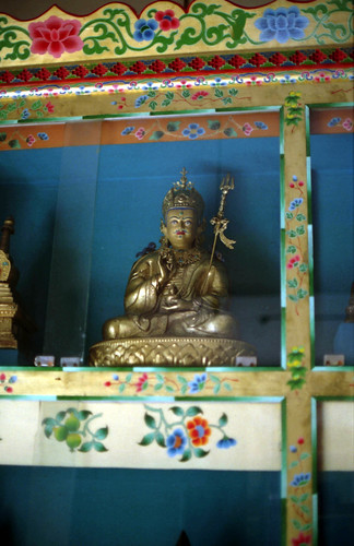 Statue of Padmasambhava holding up his dorje and staff, over the skullcup of nectar, painted case, Tibetan Works and Archives Library, Dharamsala, India by Wonderlane
