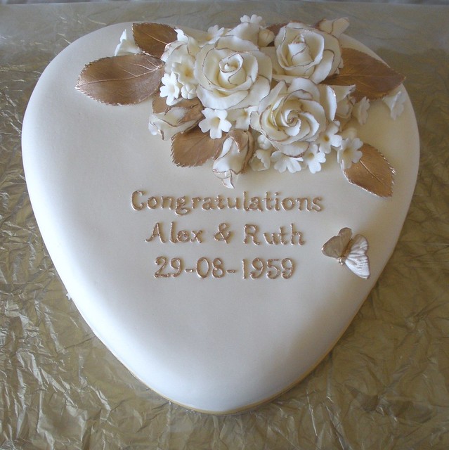For a 50th wedding anniversary Roses are edged with gold and filler flowers 