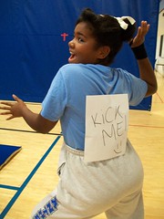 girl with Kick Me! sign on her back