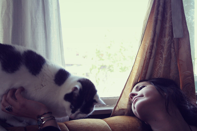 Woman with cat, daydreaming