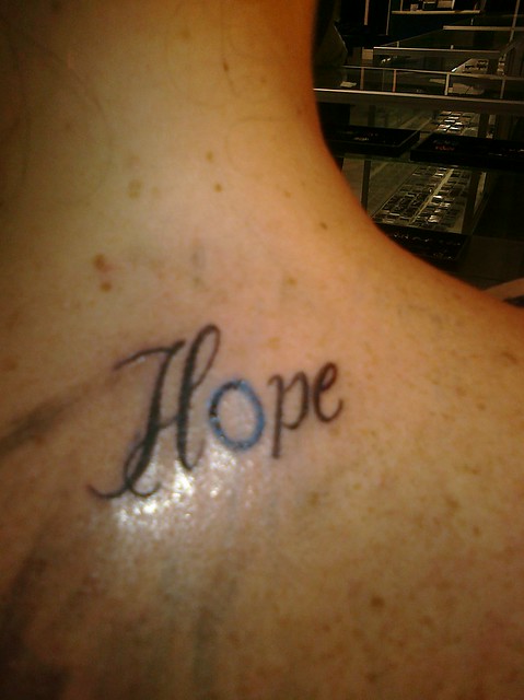  2 with a Hope tattoo incorporating the Blue Circle as the letter O