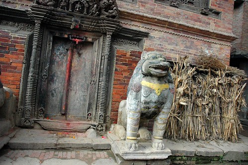 Blessed entrance, Stone Lion guardian, sheaves of grain, street scene, Kathmandu, Nepal by Wonderlane