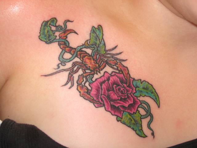 Scorpion wraped in vine holding Rose Tattoos By Sergio