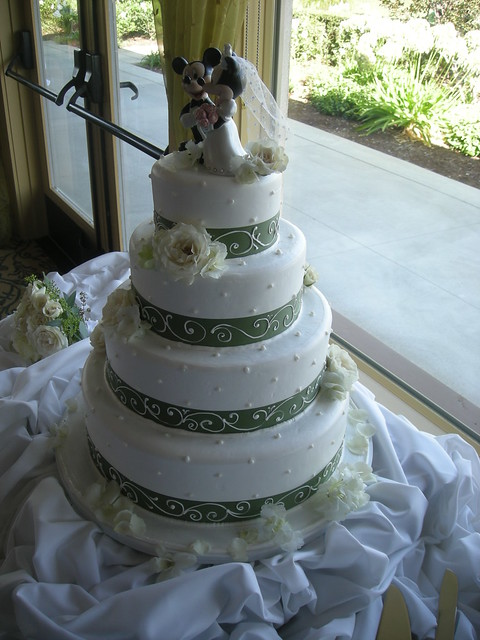 Four tier buttercream wedding cake with Minnie and Mickey Mouse toppers