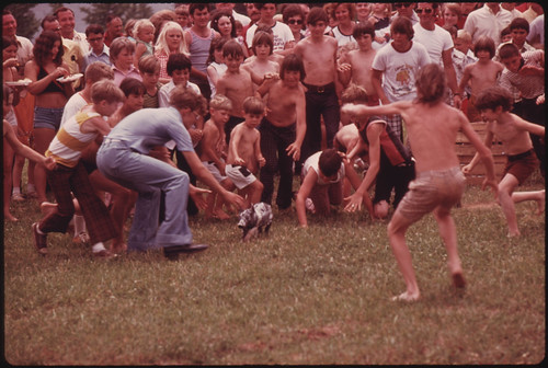 Anxious Youngsters Begin the Chase in a Greased Pig Contest at the Tennessee Consolidated Coal Company First Annual Picnic Held at a Tennessee Valley Authority Lake near Jasper and Chattanooga, Tennessee 08/1974
