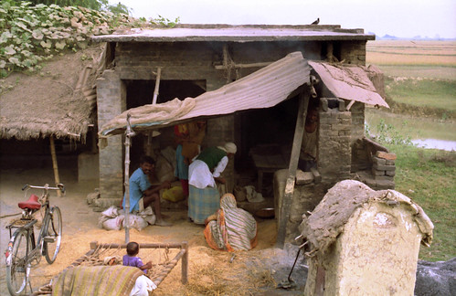 A family's power shed, family farm, bike, pond, fields, Kusinara, Lumbini, India in 1993 by Wonderlane