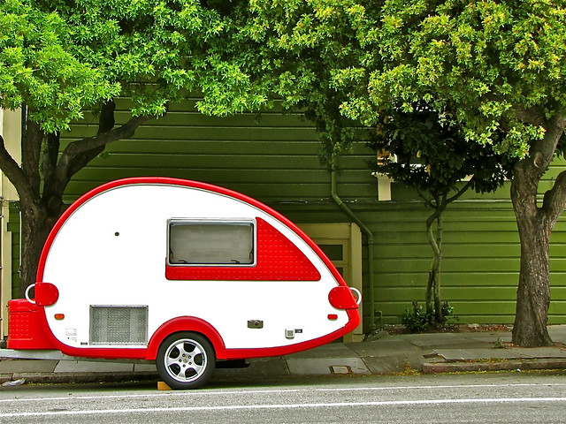 Red and white travel trailer