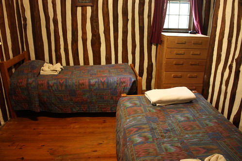 Two twin beds are in the bedroom in Cabin 9.