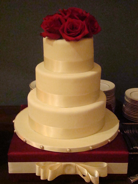 3 tier wedding covered in ivory marshmallow fondant and wrapped with an 
