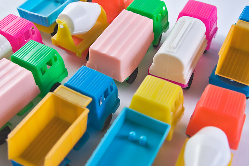 Colorful toy trucks parked together in rows