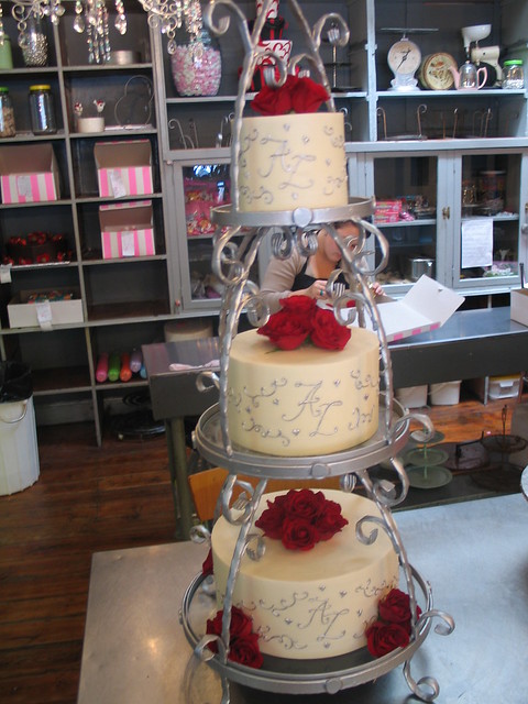 3 tier on silver stand white ganche wedding cake silver intials twirls