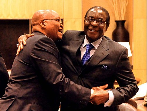 A South African government handout photo shows the-then Southern African Development Community (SADC) chairman, South African President Jacob Zuma (L), hugging Zimbabwean President Robert Mugabe on June 20, 2009 in Johannesburg. by Pan-African News Wire File Photos