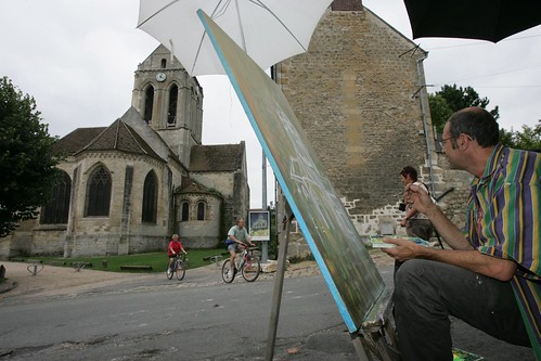 Artists in Auvers-sur-Oise do their best to capture the church made famous by Van Gogh. Photo: Pierre Marcel  