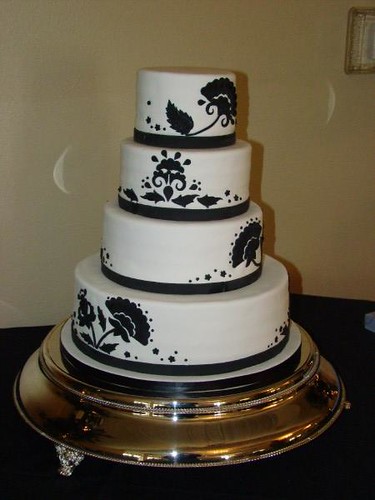 4 tier wedding cake with a black and white floral pattern It has damask 