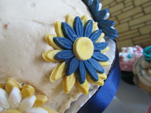 Blue and Yellow Daisythemed Wedding Cake A yellow and navy blue fondant
