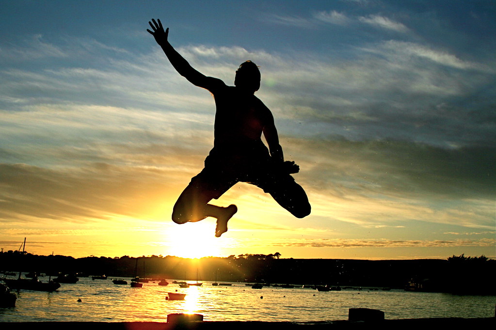 Jumping into the sea at sunset. Using the self timer