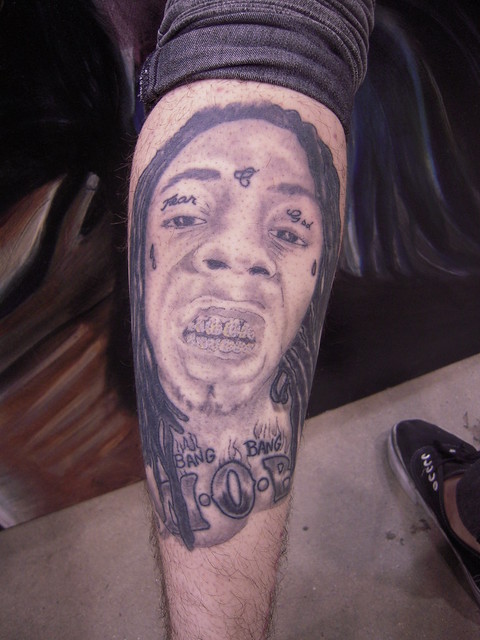 A staff member at Master Mind Ink has a tattoo of rapper Lil' Wayne