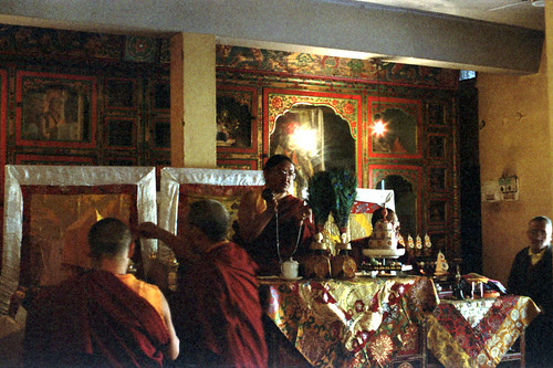 HH Sakya Trizin ringing tingsha bells, mandala offerings and initiation, on his throne with peacock feather vases, mandala, tea cup, diety torma offerings, monks, and his son, Rajpur, HP, India by Wonderlane