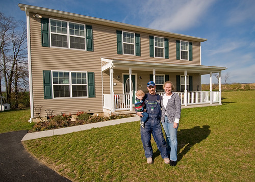 Peter, Sarah and PJ Riggio pose for a photograph in front of their new home in Newville, Pennsylvania. The Riggios were able to purchase their home with a loan from the United States Department of Agriculture, Rural Development, Self-Help Housing Loan Program.